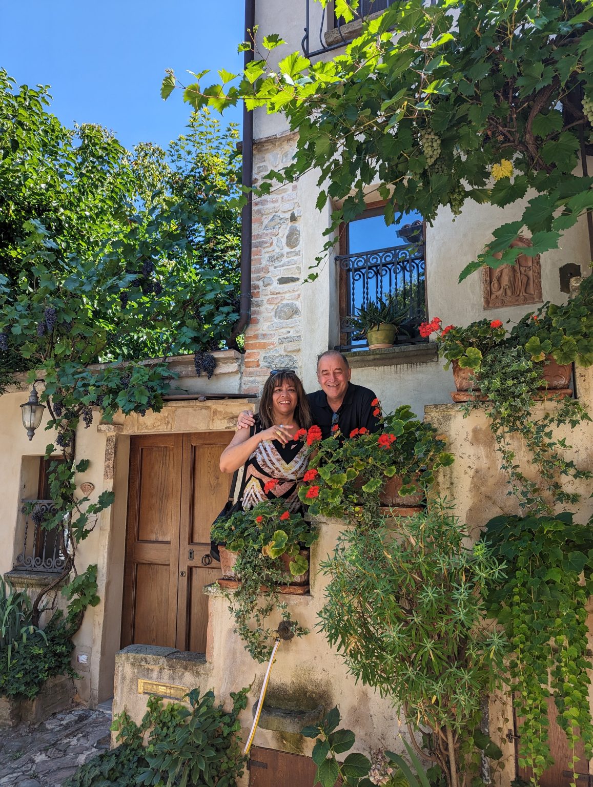 Gianni and Fanny among the vines and red geraniums