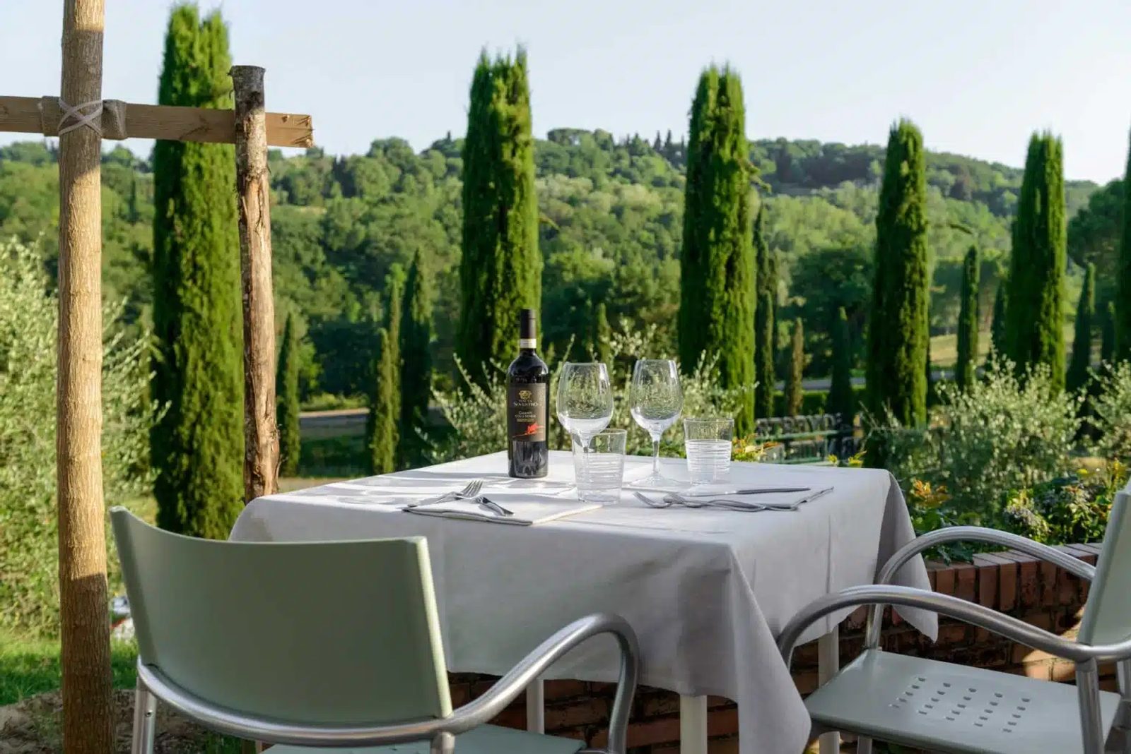 Dinner table on a terrace among the Tuscan cypresses