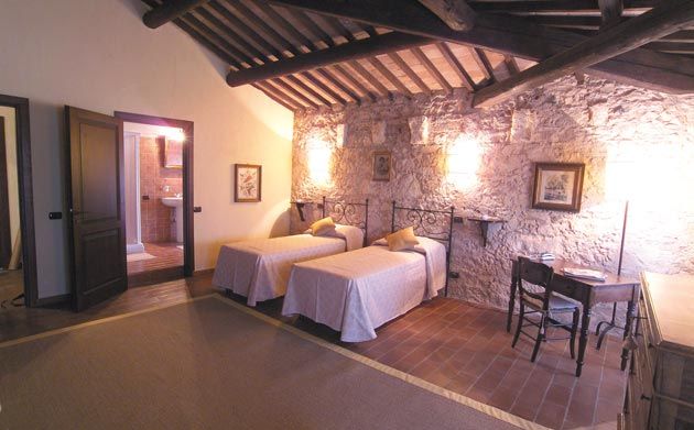 A stone-walled room with wooden beams